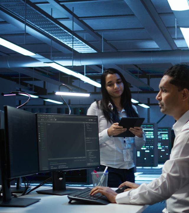 team of programmers in high tech data center troubleshooting issues